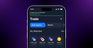 Écran mobile montrant une application de trading avec solde et paires de devises.