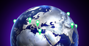 Une planète Terre avec des marqueurs verts de localisation sur plusieurs continents.